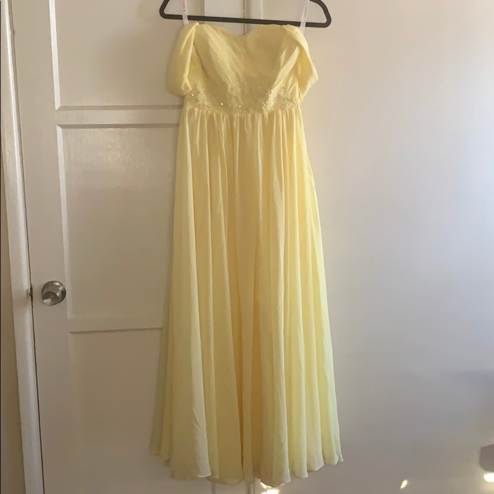 A beautiful, yellow dress that drapes gracefully.